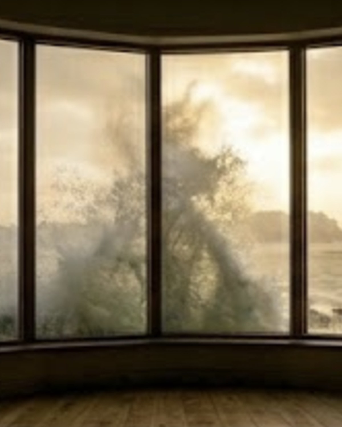 The Storm Room — a curved bay window in oiled oak frames looking directly out across the bay during a winter storm, a wave breaking against the glass at golden hour, the timber floor and quiet interior of a small contemplative room